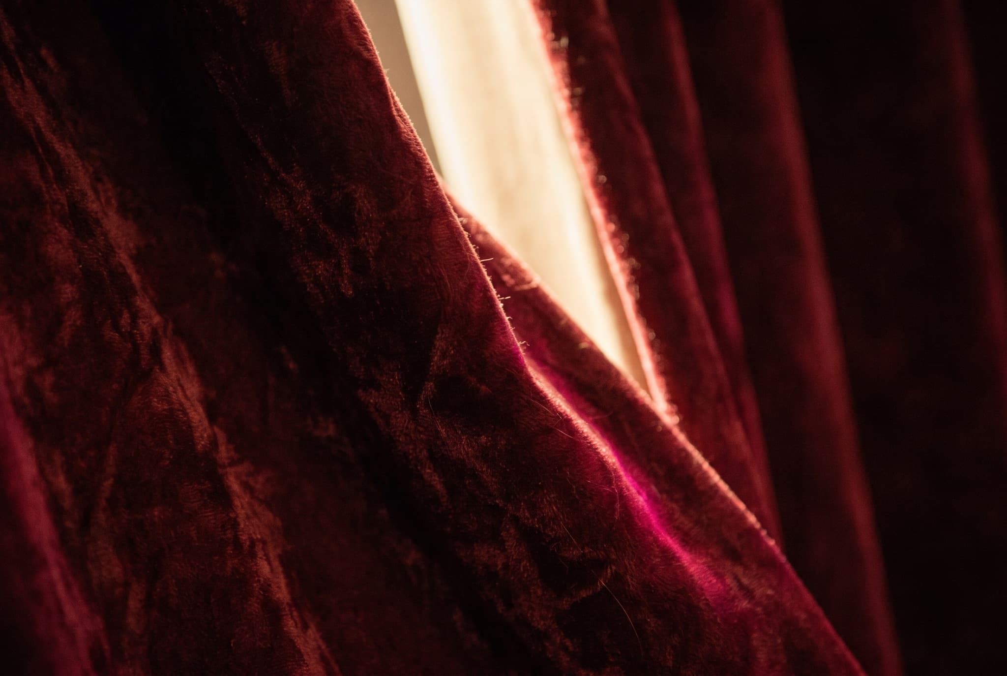 A stage curtain lit from the wings