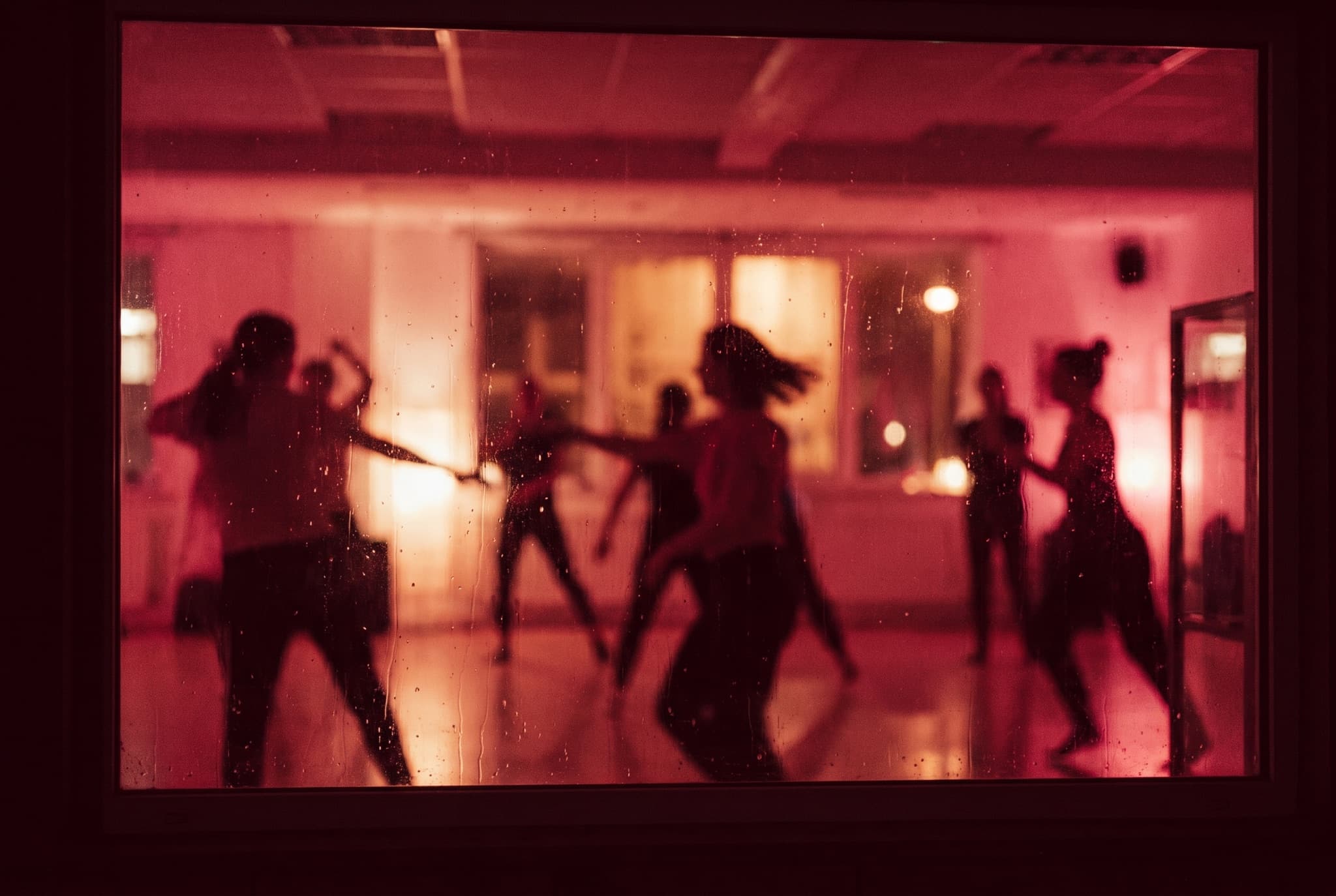A dance class rehearsing in a mirrored studio